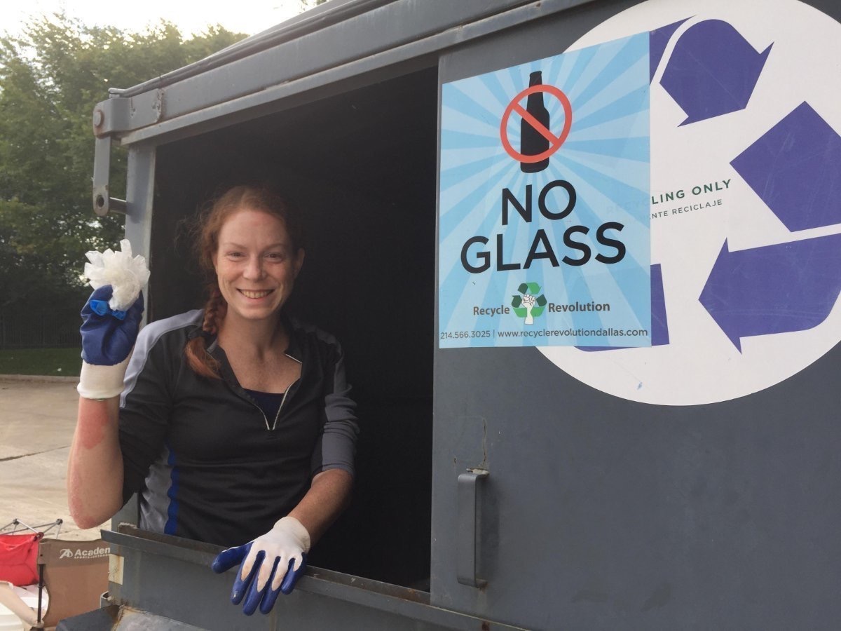 Volunteer decontaminating the recycling dumpster at Embassy Suites Dallas